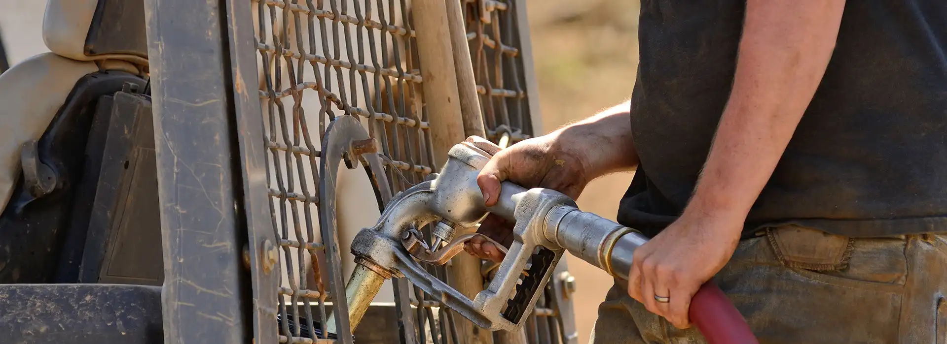 Man filling up construction machinery with diesel or HVO