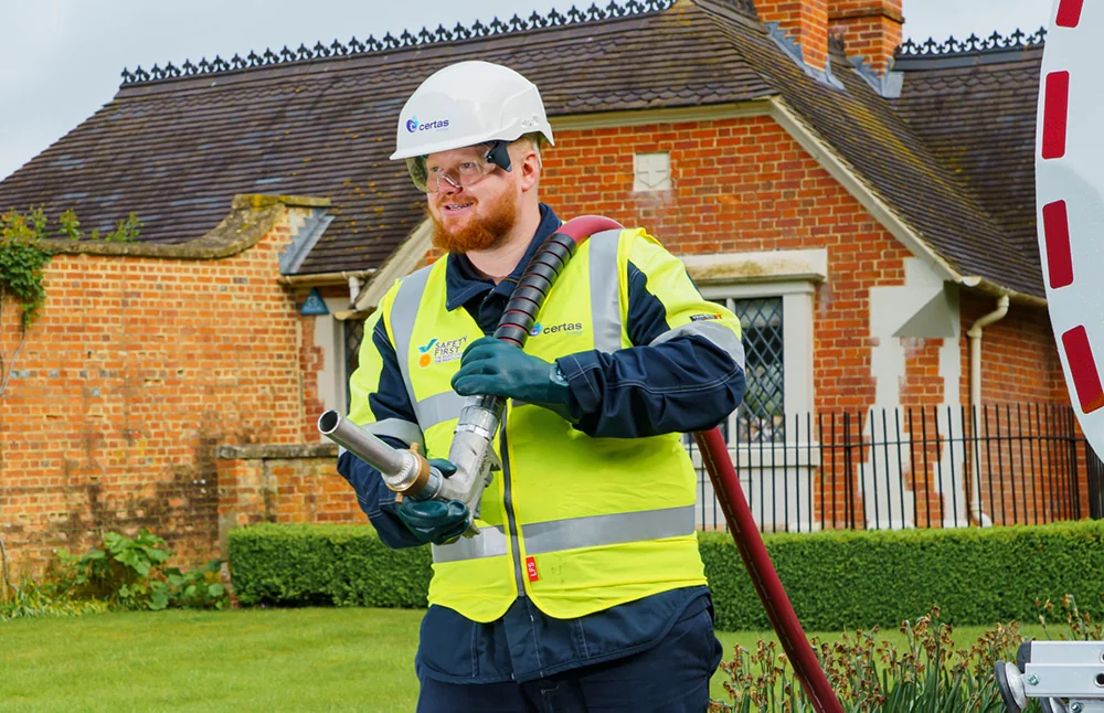 Man wearing hi-vis vest and hard hat with Certas Energy branding.