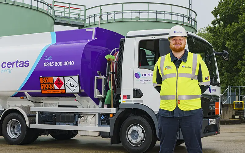 Certas Energy employee stood in next to a branded truck.