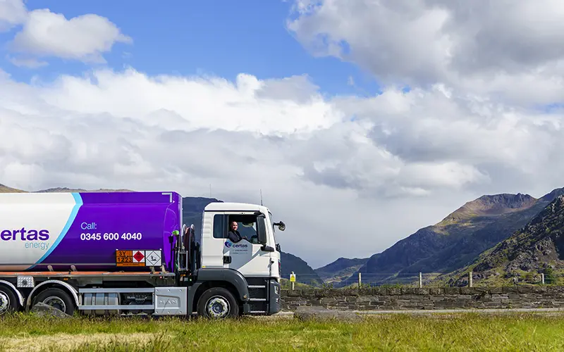 Certas Energy delivery truck driving through countryside.