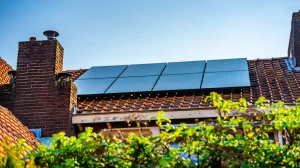 Solar panels on roof with sunny conditions and blue skies