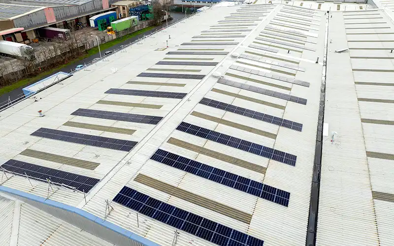 Commercial building roof with solar panels attached.